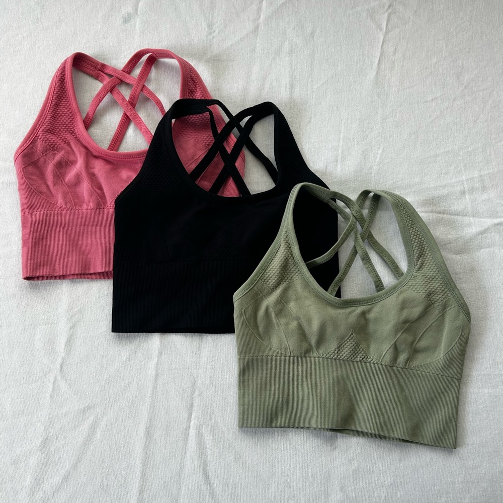 Pink, mint, green, and black sports bras